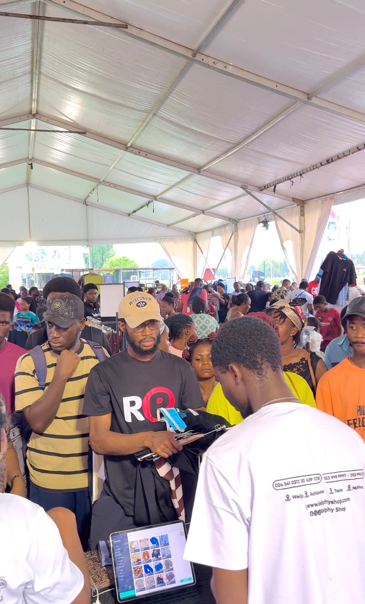 A packed festival tent and active checkout station