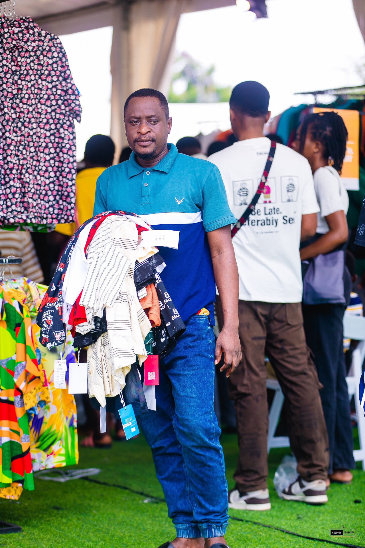 A shopper carrying a large selection of Kelphy clothing