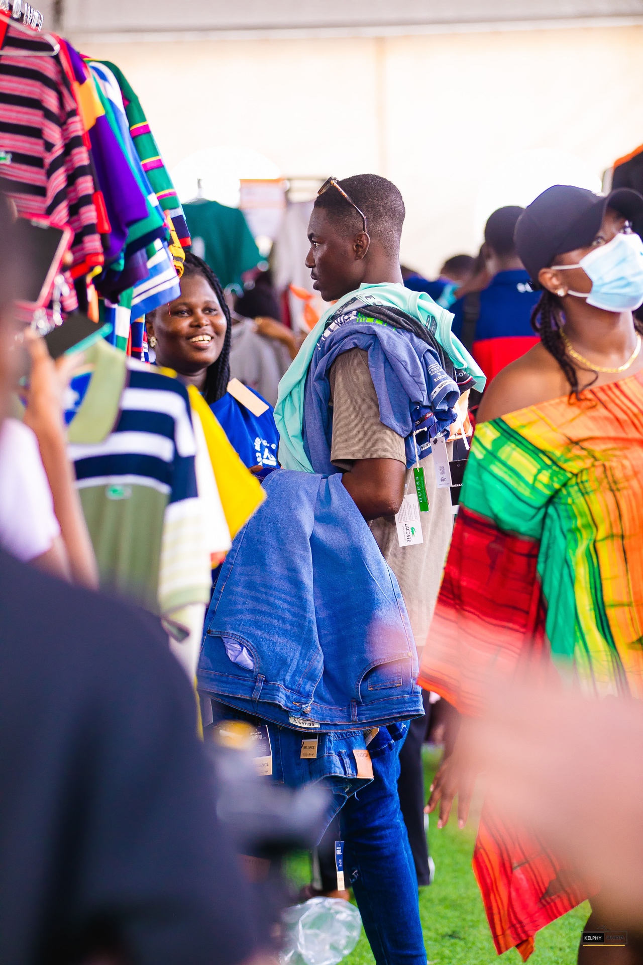 Shoppers browsing colourful clothing racks
