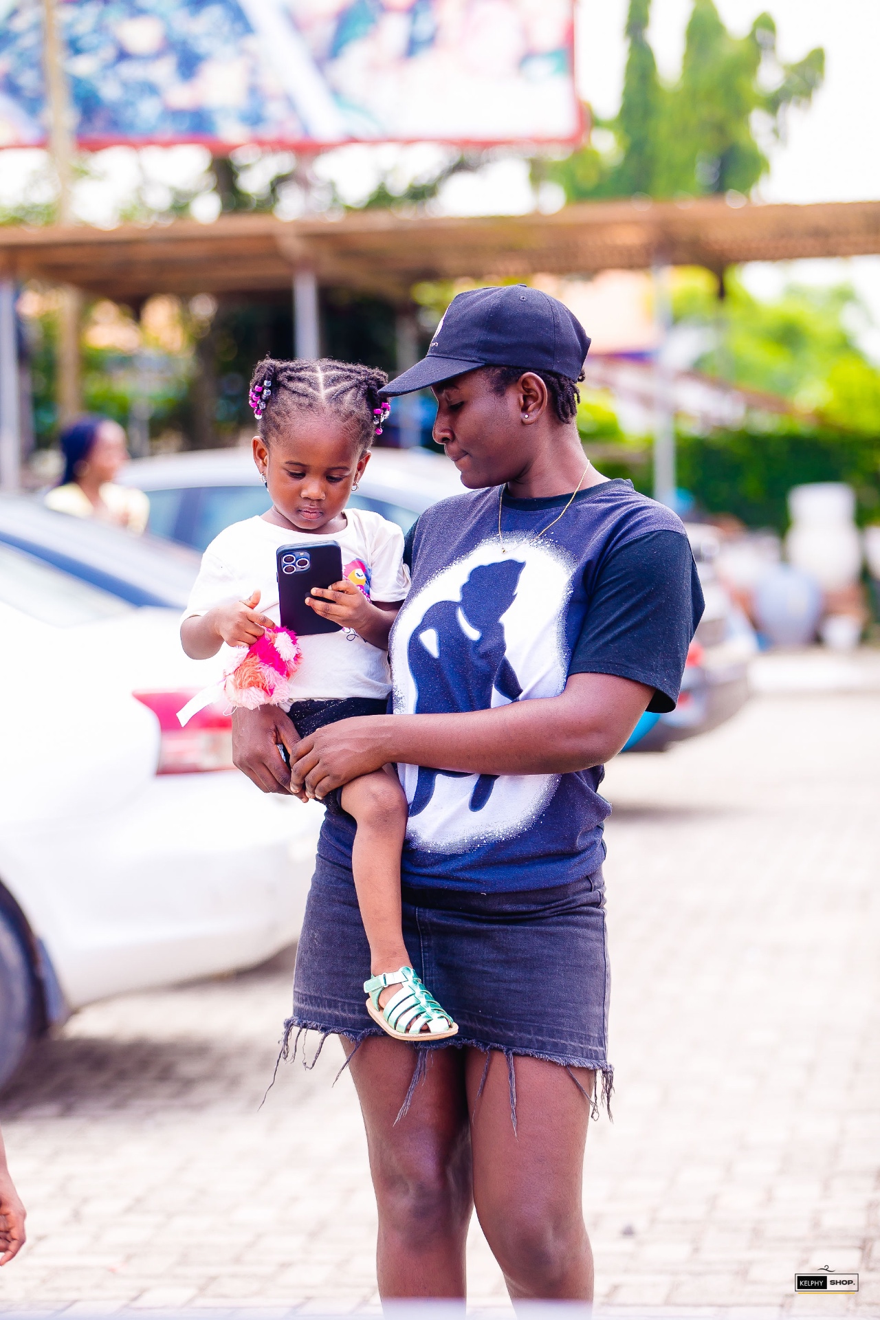 An adult and child enjoying the festival outside the tents