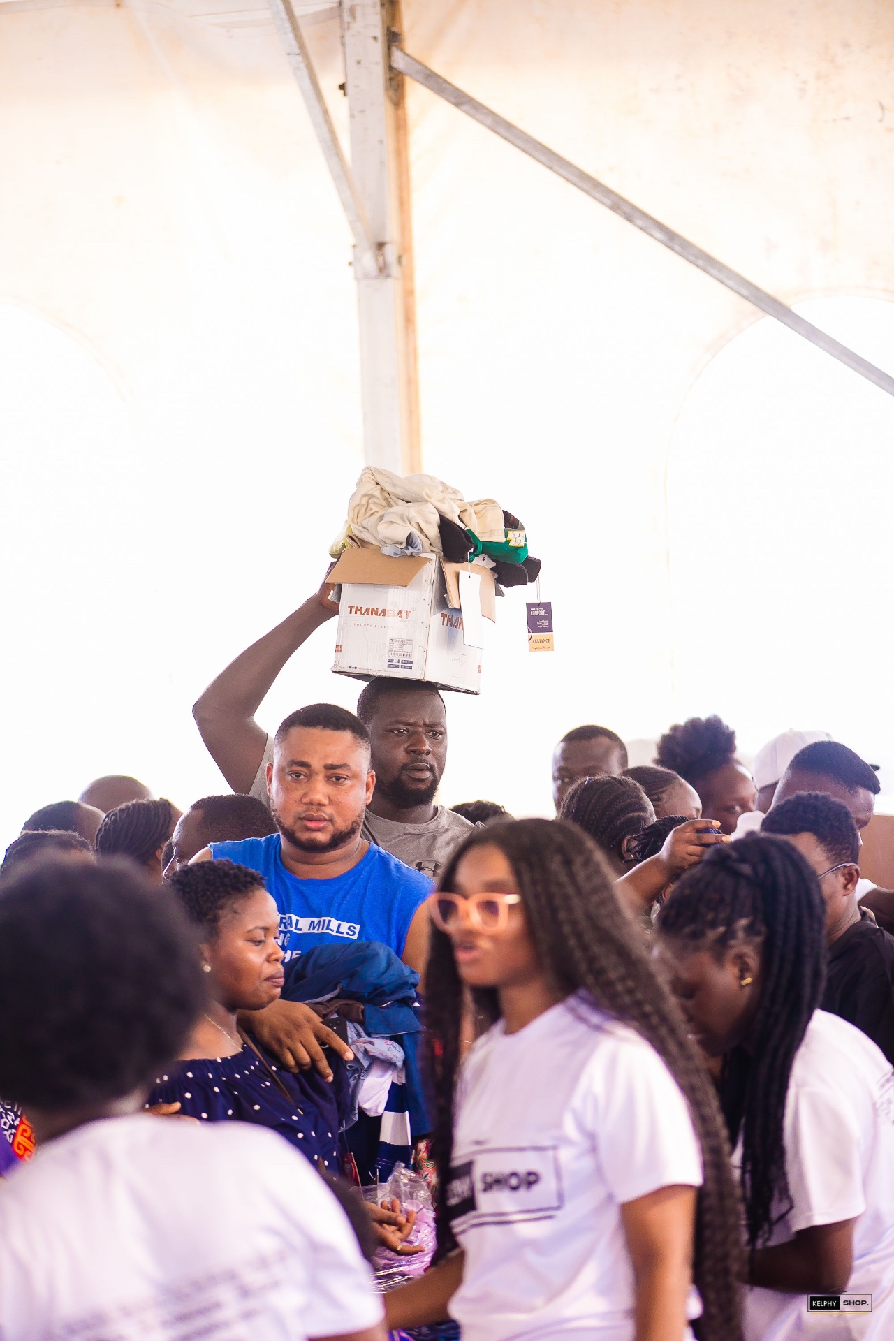 Festival guests shopping with clothing and boxes