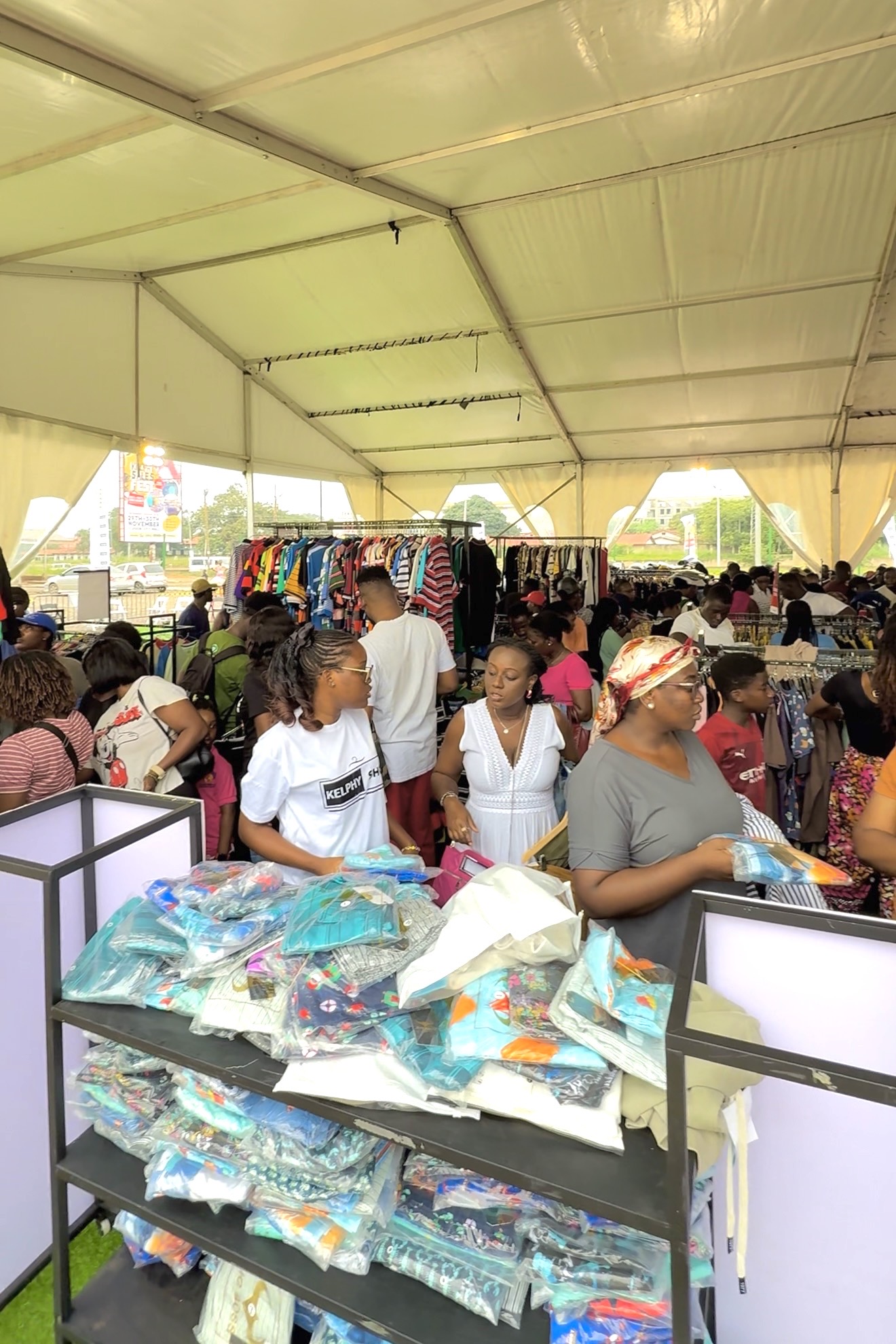 Shoppers filling a large Kelphy clothing tent